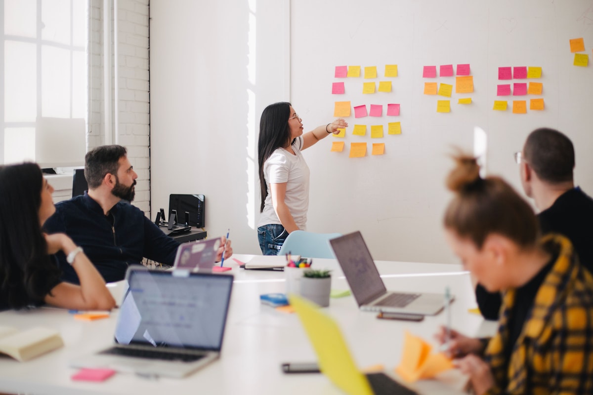 A team mapping out a problem with sticky notes on a whiteboard